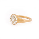 Yellow gold ring with diamond cluster daisy flower on a white background