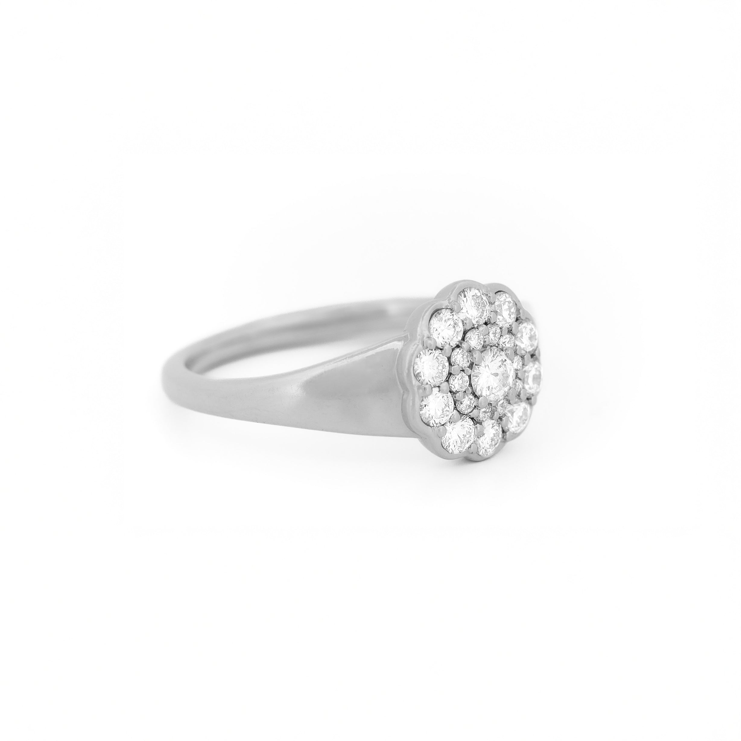 White gold ring with diamond cluster daisy flower on a white background