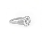 White gold ring with diamond cluster daisy flower on a white background