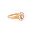 Yellow gold ring with diamond cluster daisy flower on a white background