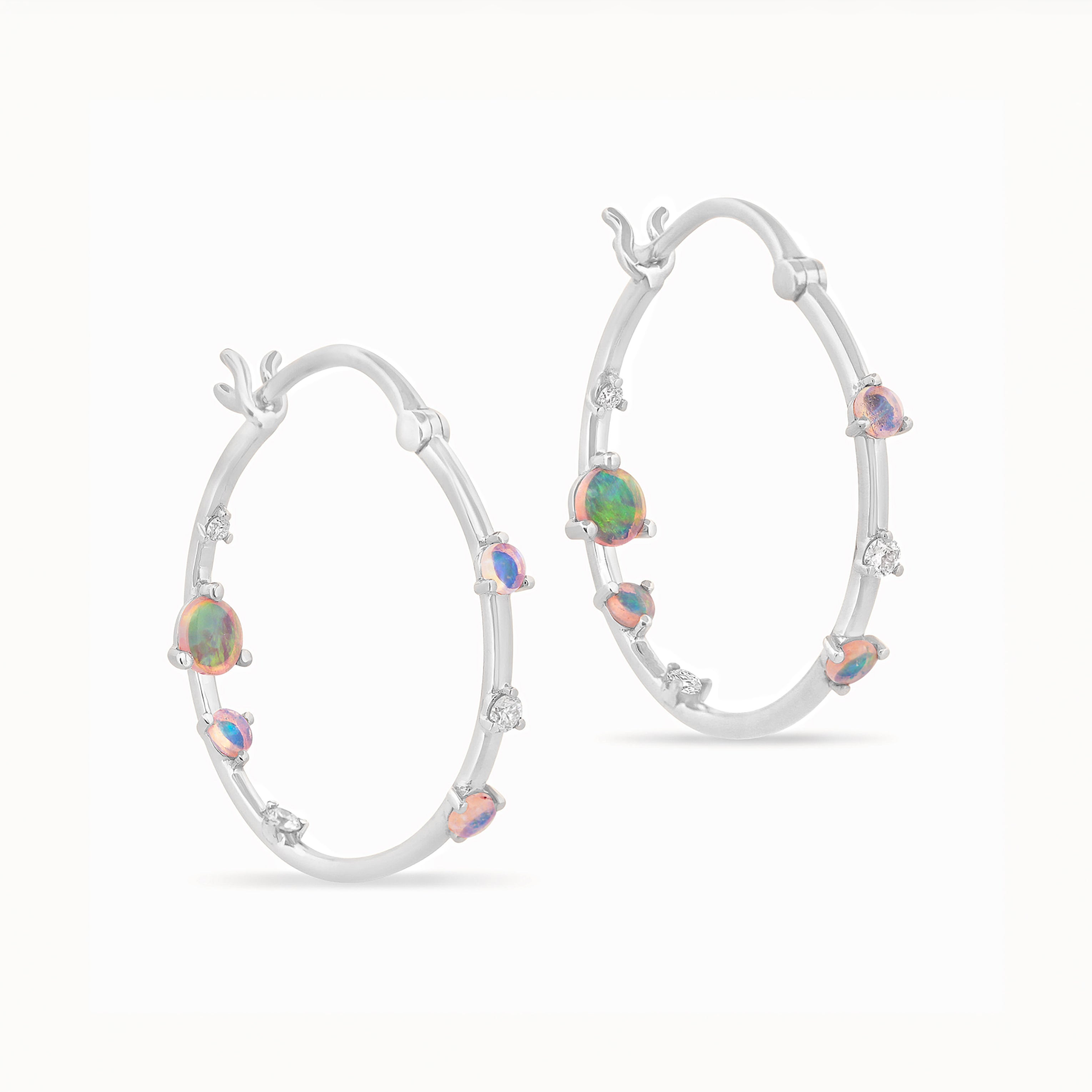 Gold hoop earrings with embedded Australian opals and diamonds on a white background
