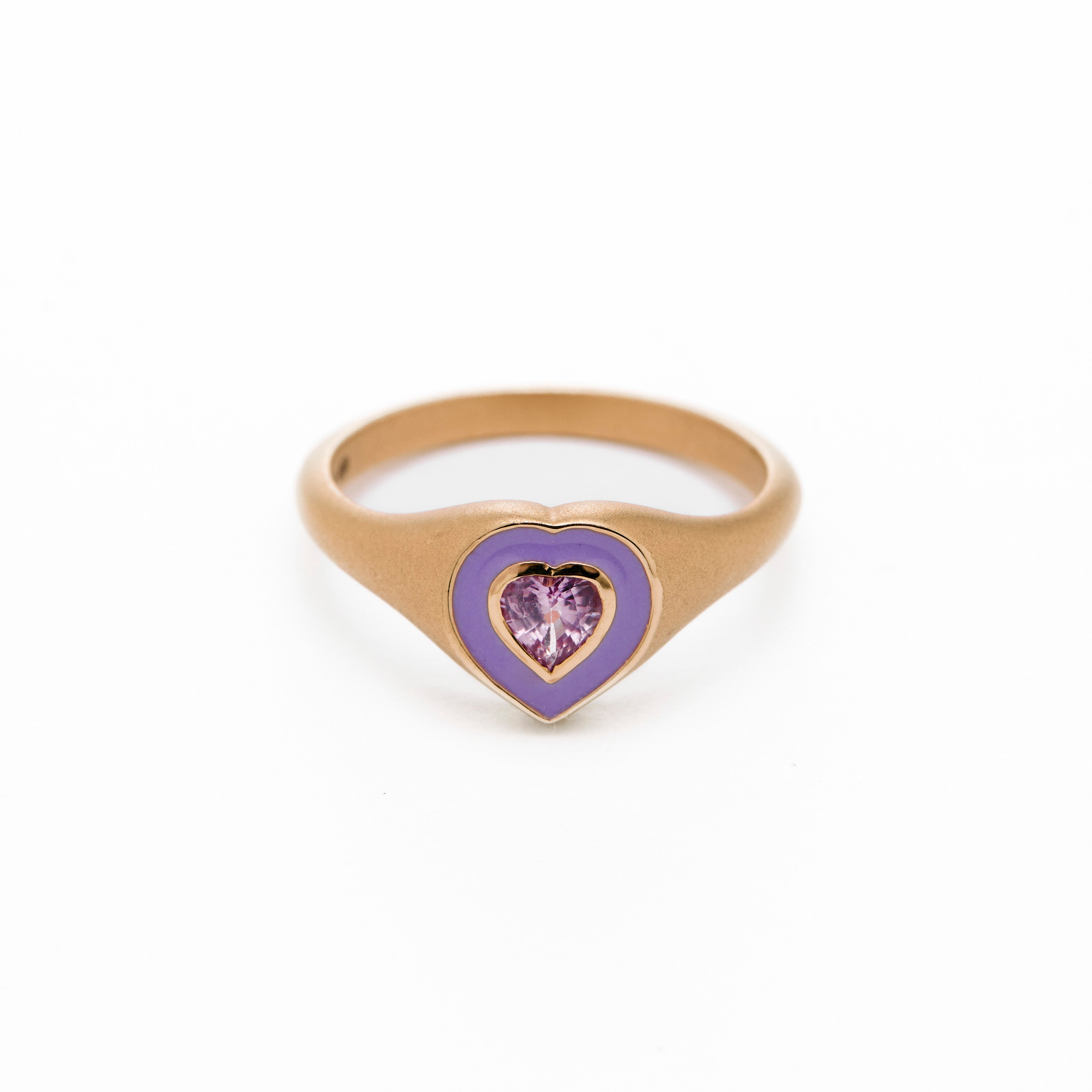 a colorful purple enamel ring with middle sapphire heart
