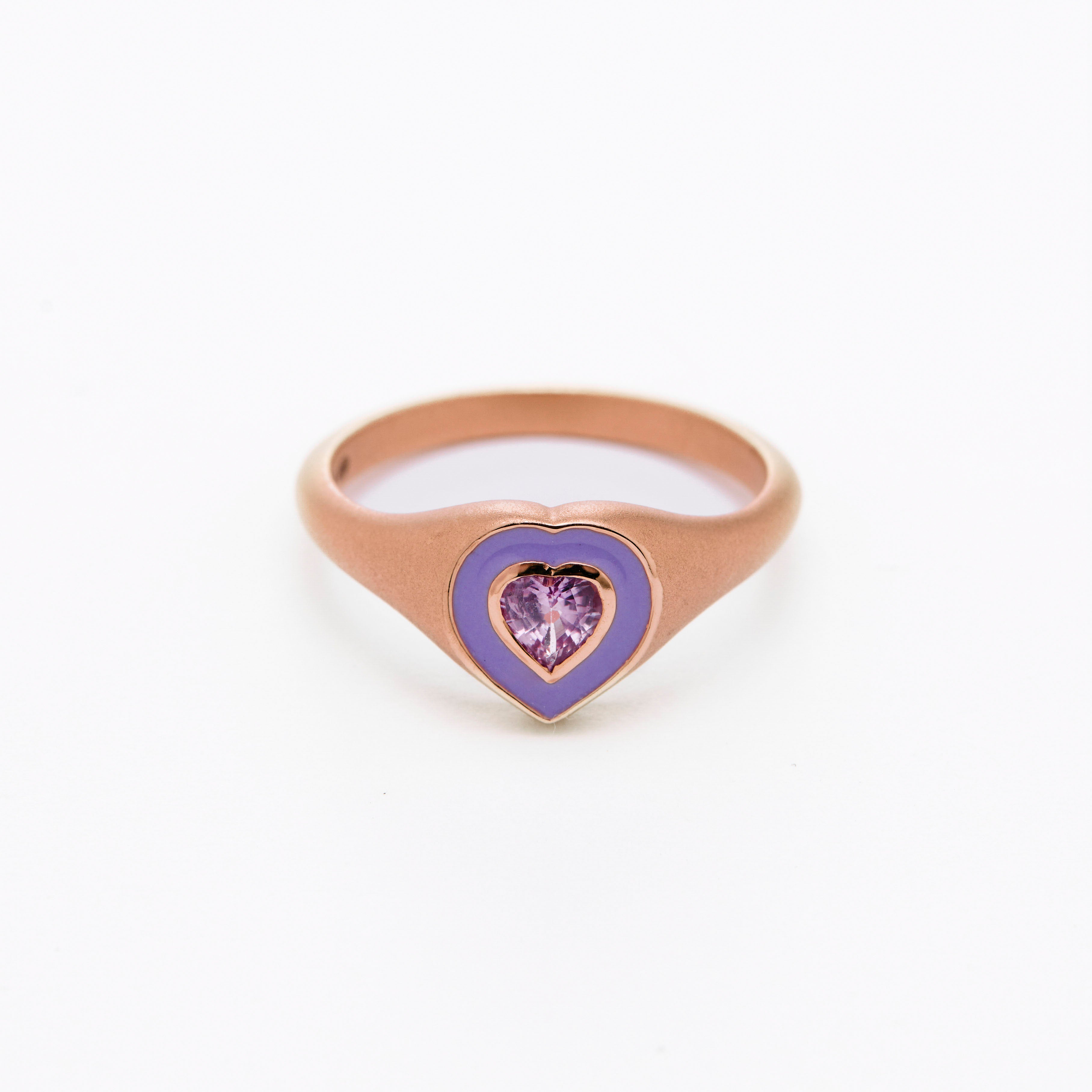 a colorful purple enamel ring with middle sapphire heart