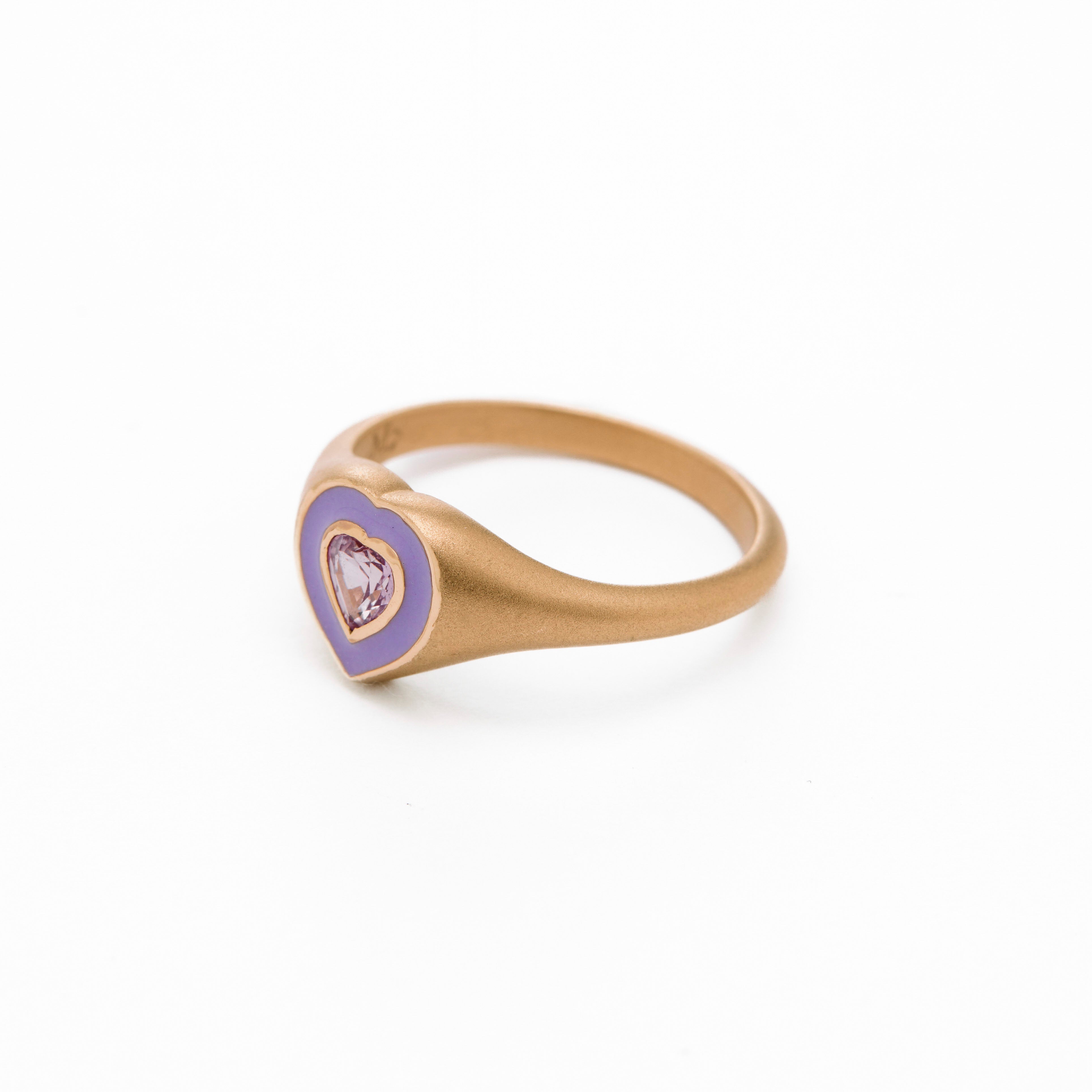 a colorful purple enamel ring with middle sapphire heart