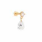 Gold earring with a teardrop-shaped Diamond on a white background