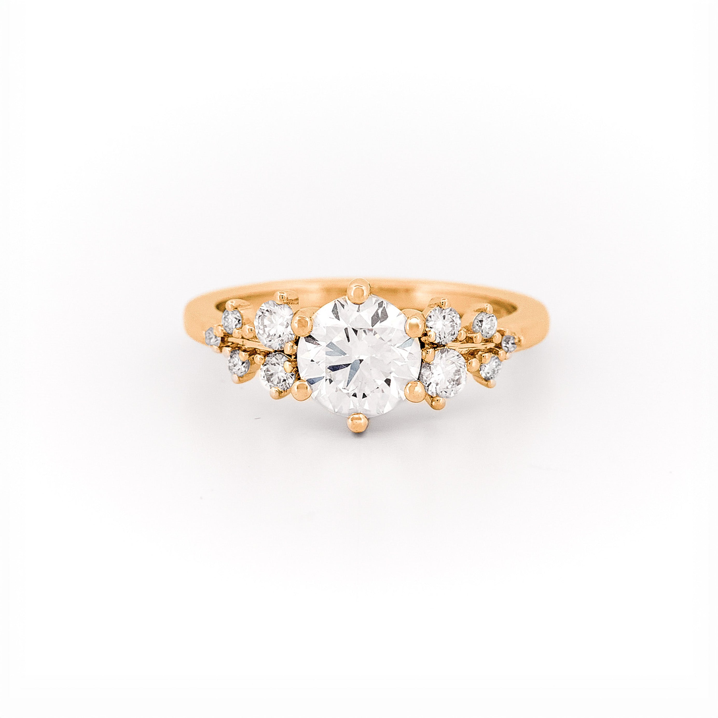 Gold and a floral diamond ring on a white background