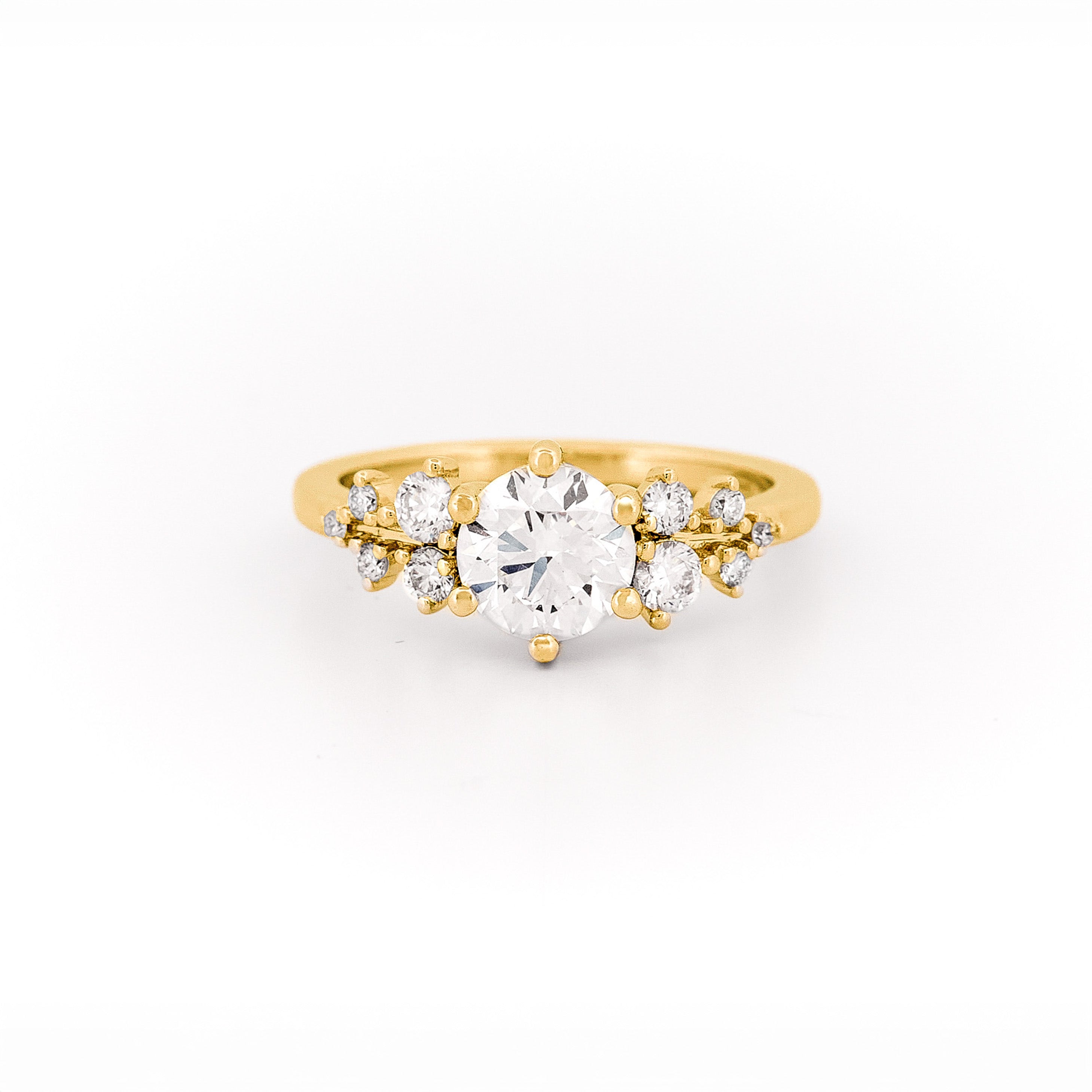 Gold and a floral diamond ring on a white background