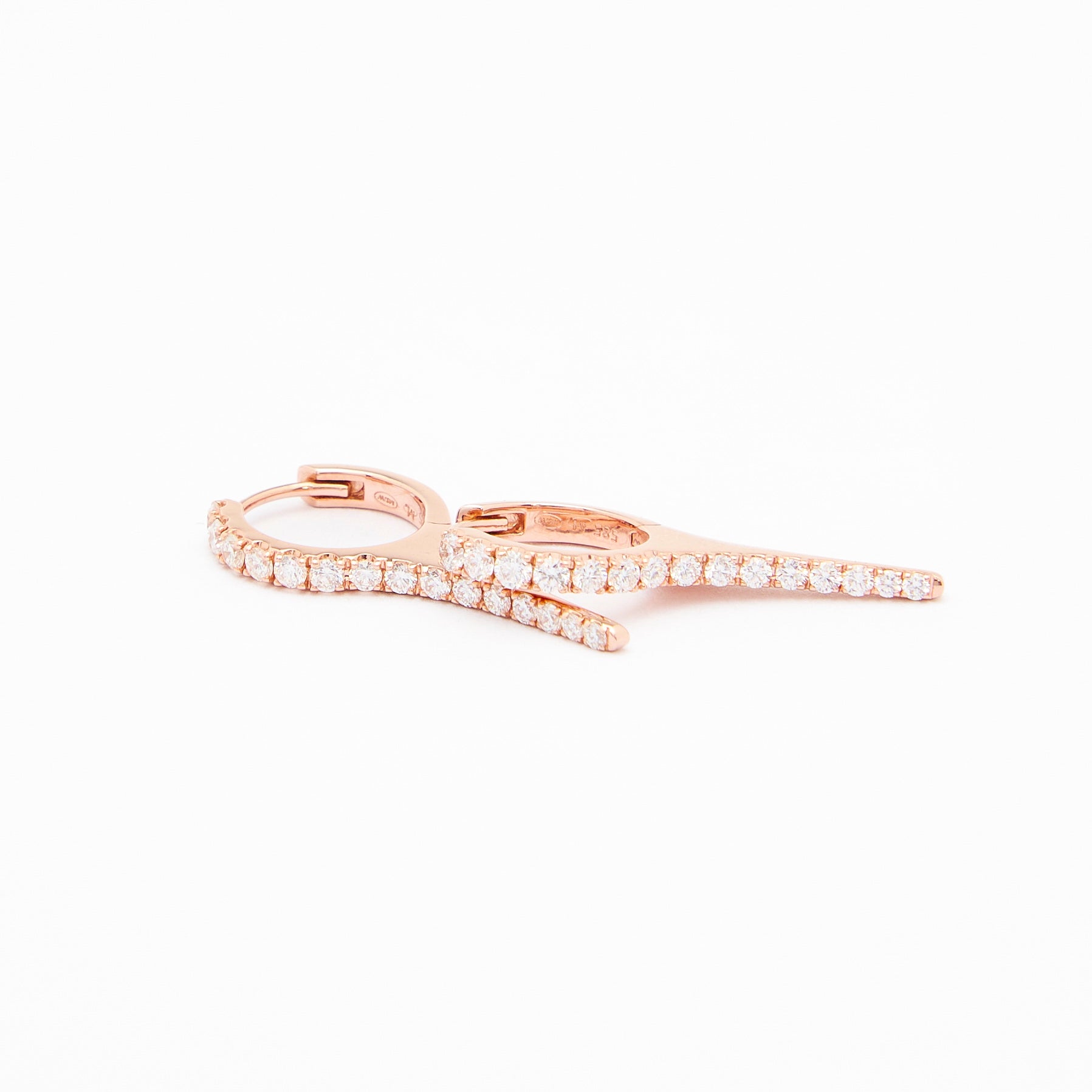A pair of rose gold earrings with natural diamond drops, featuring a minimalist design.