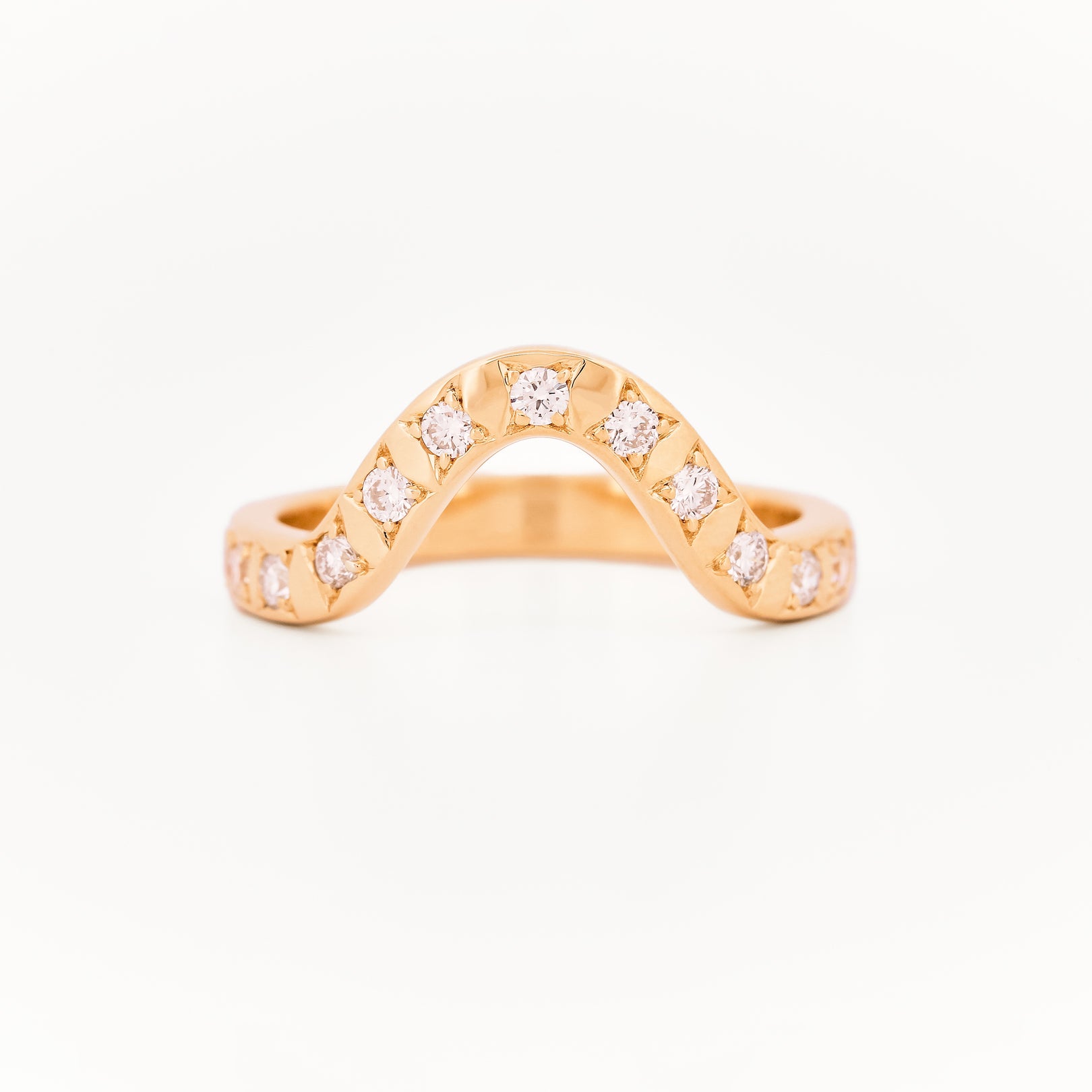 Yellow gold 2.5 mm band ring with 3 round diamondsdiamonds on a white background.