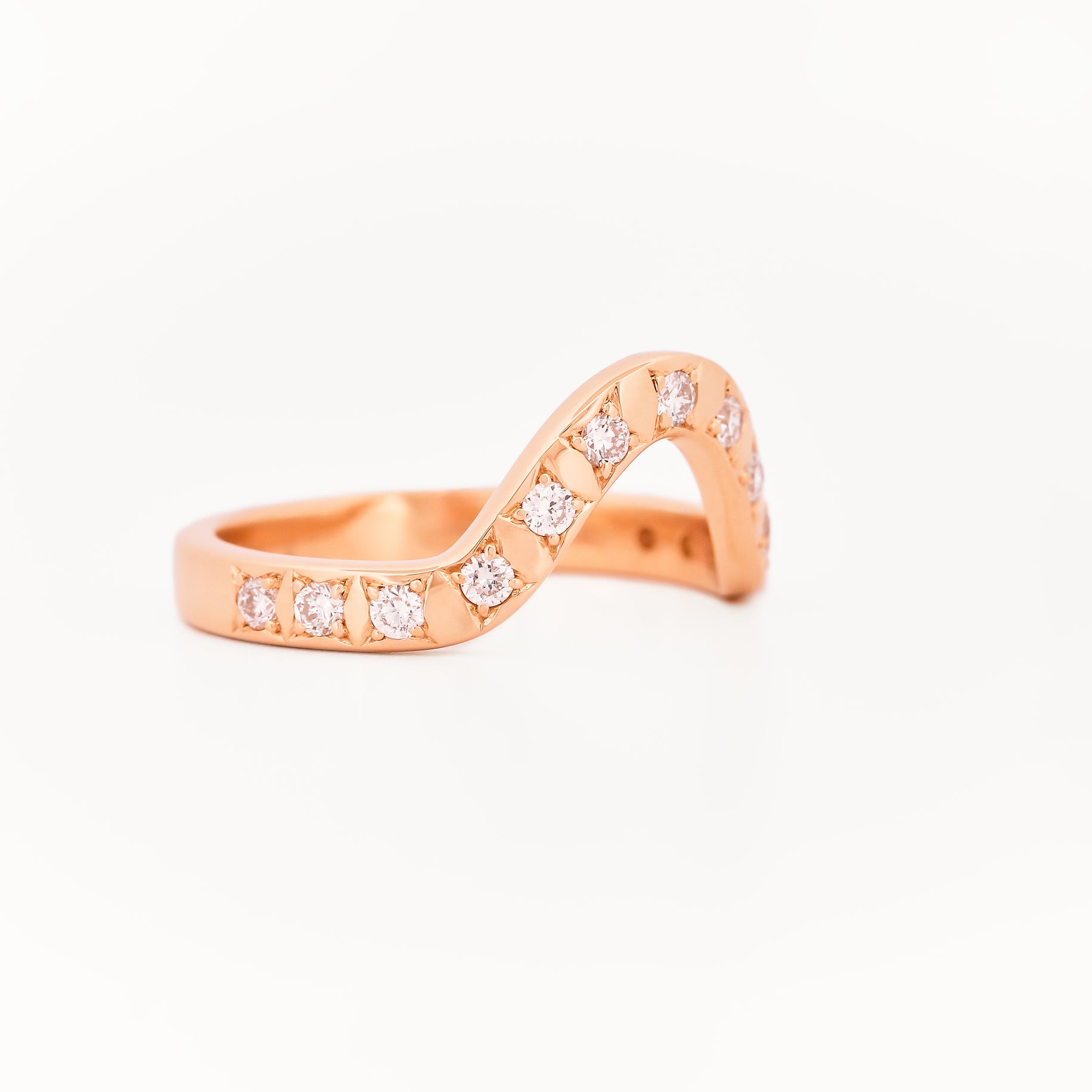 Yellow gold 2.5 mm band ring with 3 round diamondsdiamonds on a white background.