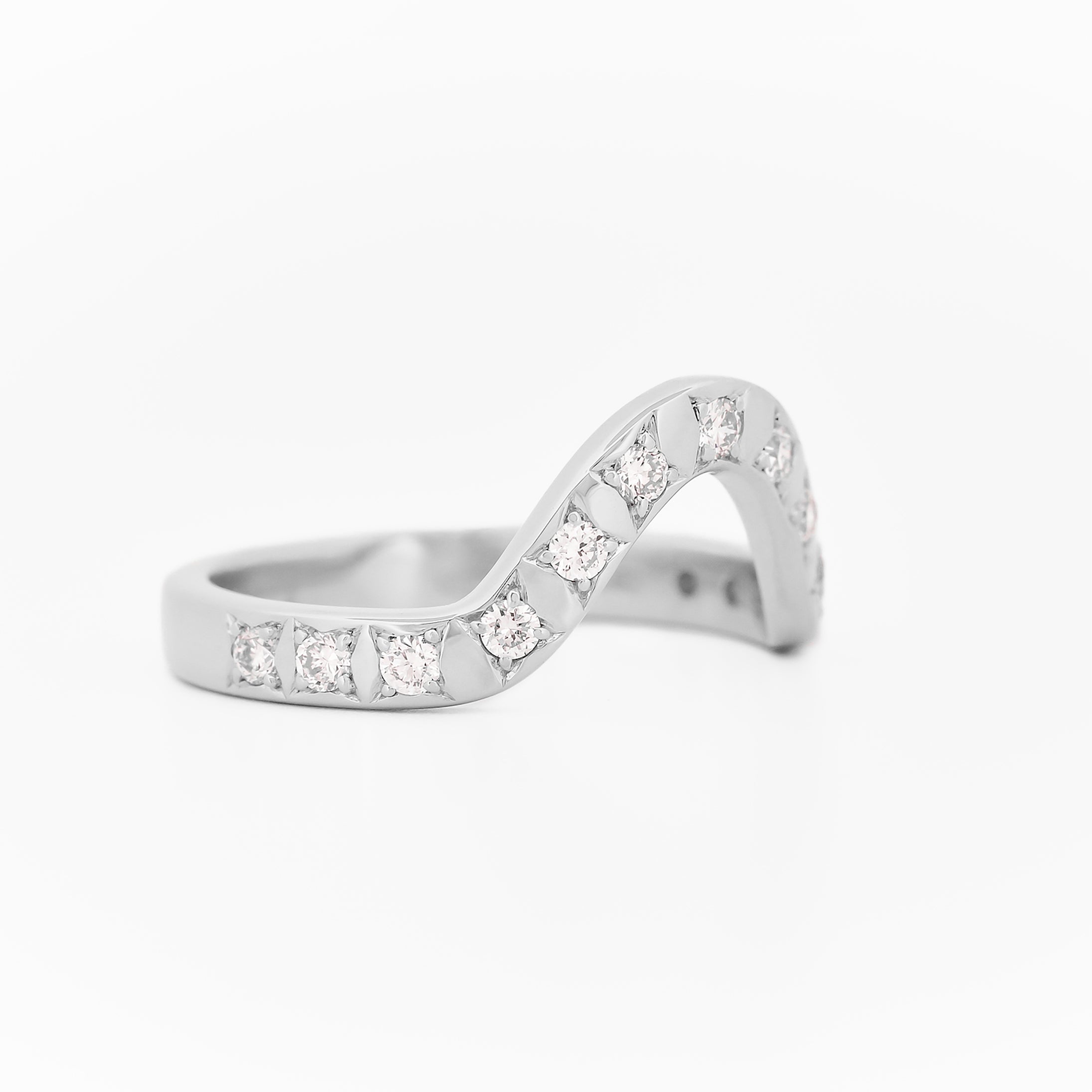 White gold 2.5 mm band ring with 3 round diamondsdiamonds on a white background.