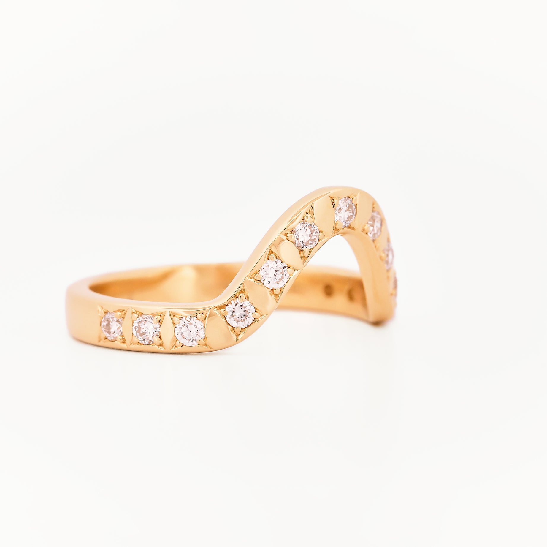 Yellow gold 2.5 mm band ring with 13 round diamonds  diamonds on a white background.