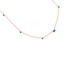 Necklace with emeralds gemstones on a white background