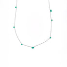Necklace with emeralds gemstones on a white background