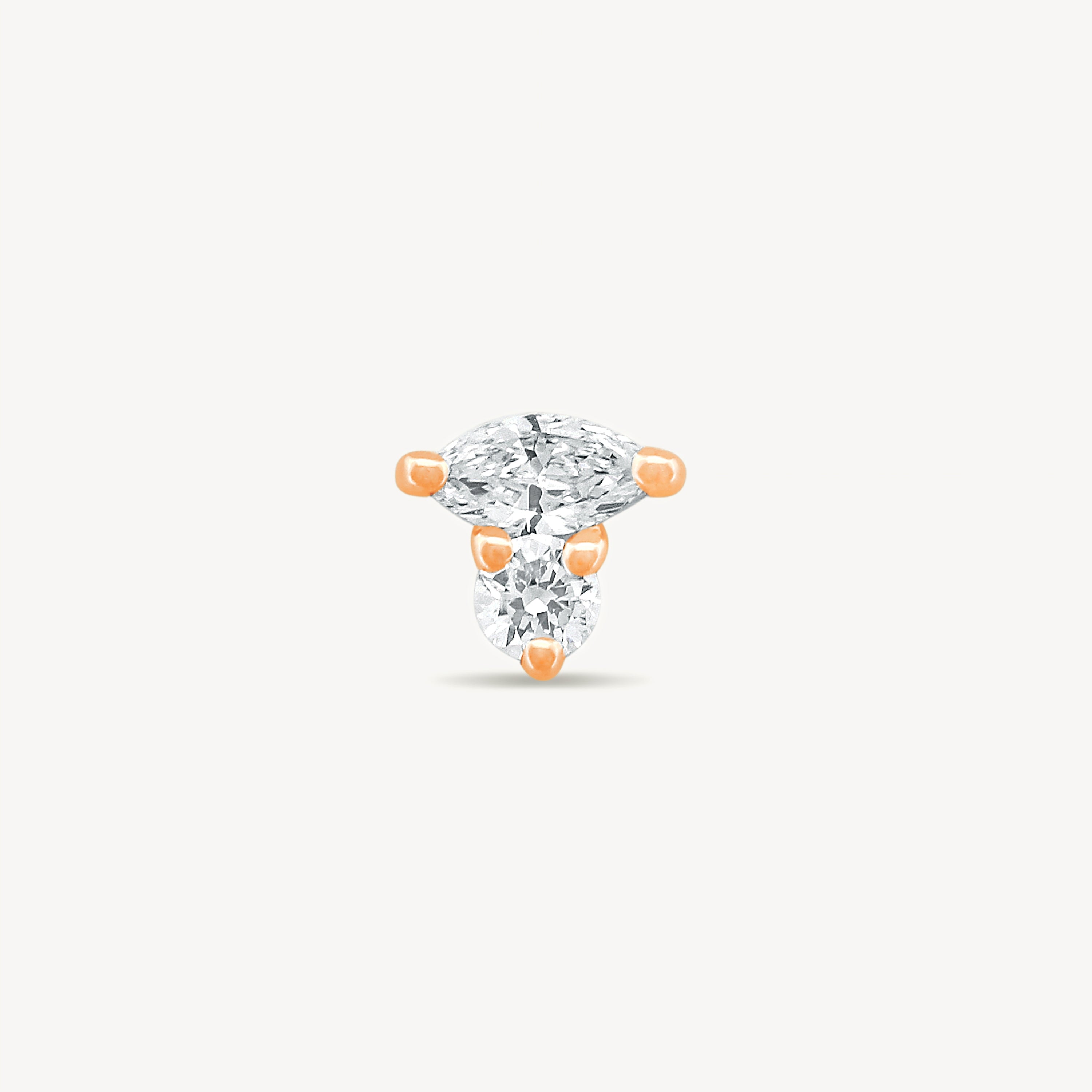 Rose gold Marquise and round Diamond stud earring with on a light gray background