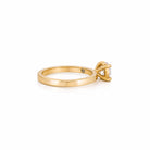 Gold ring with a diamond on a white background