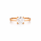Rose gold ring with a solitaire 1 ct diamond on a white background