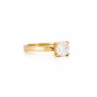 Solitaire gold ring with a 1 ct natural diamond, on a white background