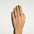 Solitaire gold ring with a 1 ct natural diamond, an eternity diamond band and a kite diamond pinky ring on hand