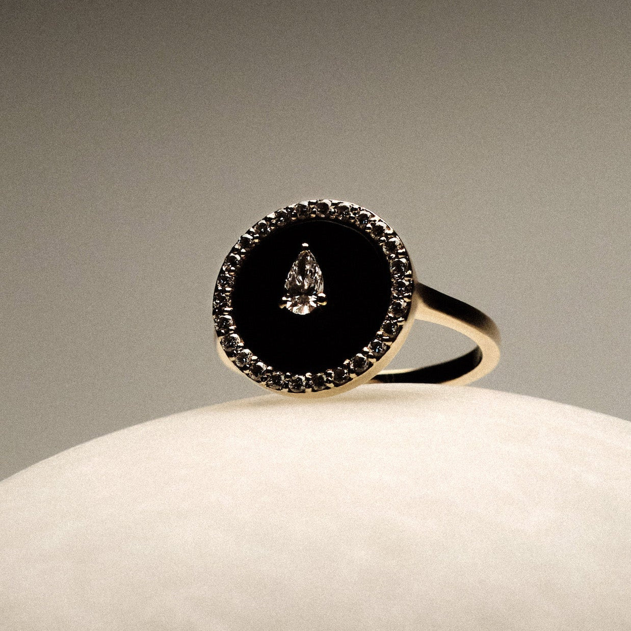 Black Onyx and diamonds Gold Ring on a round marble.