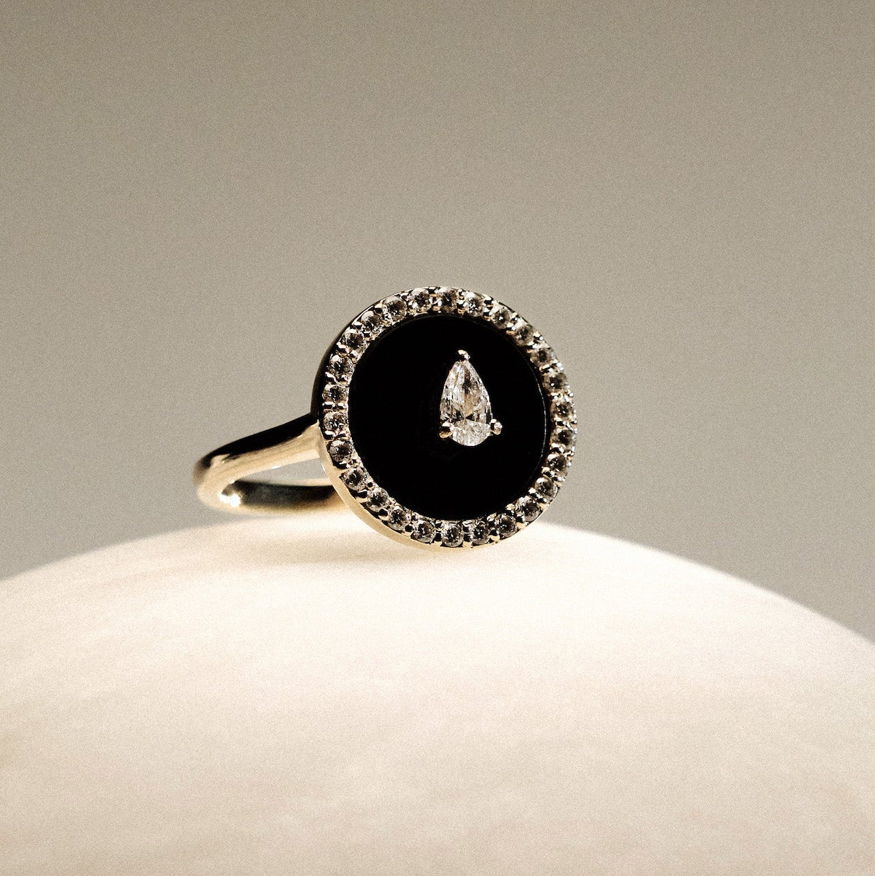 Black Onyx and diamonds Gold Ring on a round marble.