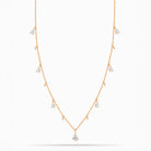 Rose Gold necklace with teardrop and round diamond pendants on a white background