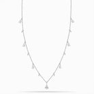 White Gold necklace with teardrop and round diamond pendants on a white background