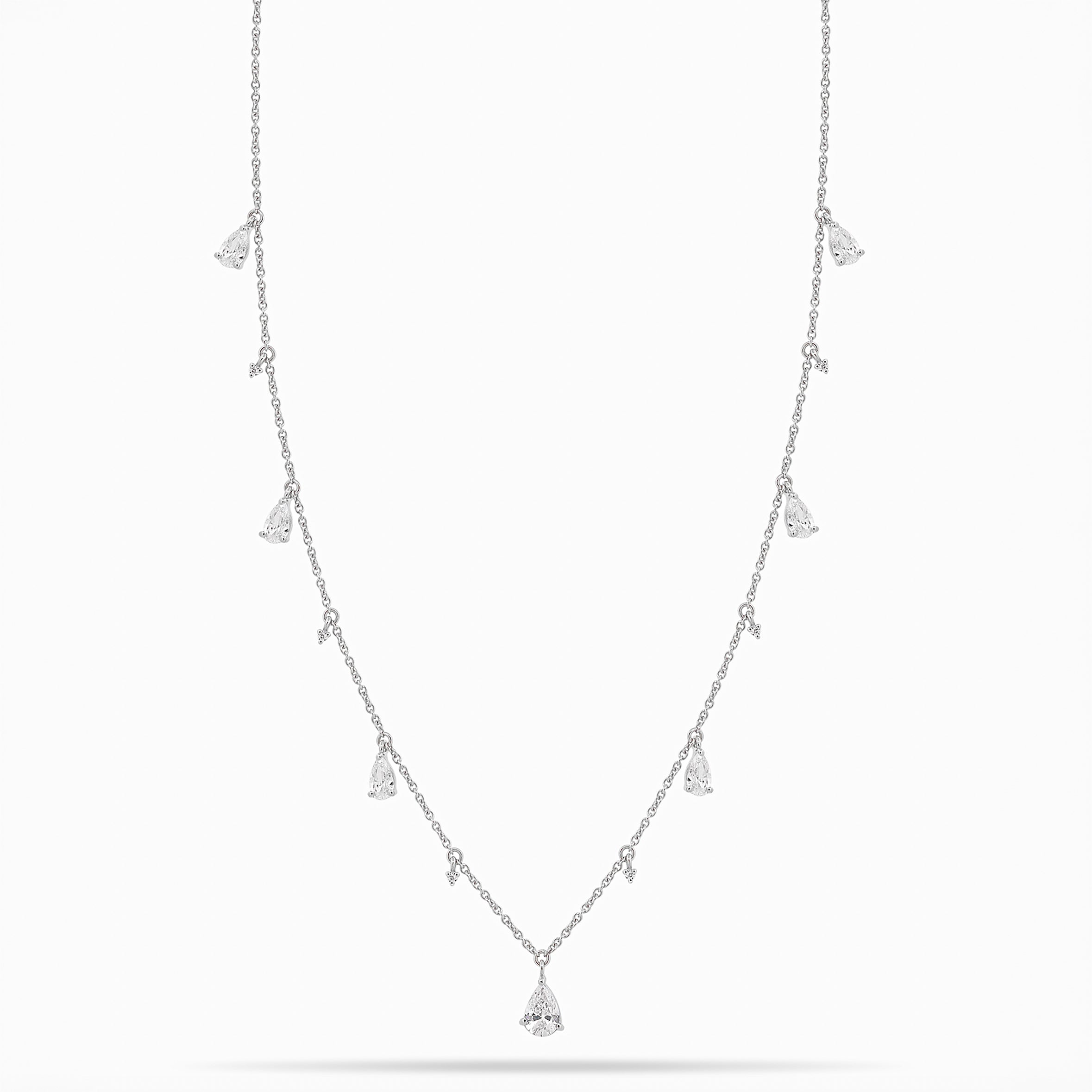 White Gold necklace with teardrop and round diamond pendants on a white background