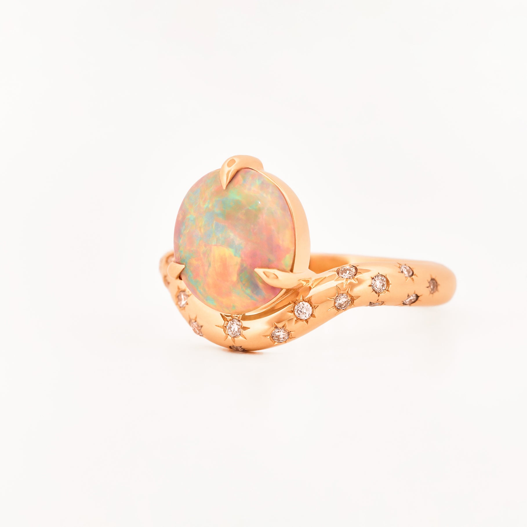 Rose Gold ring with an australian opal centrestone on a white background.
