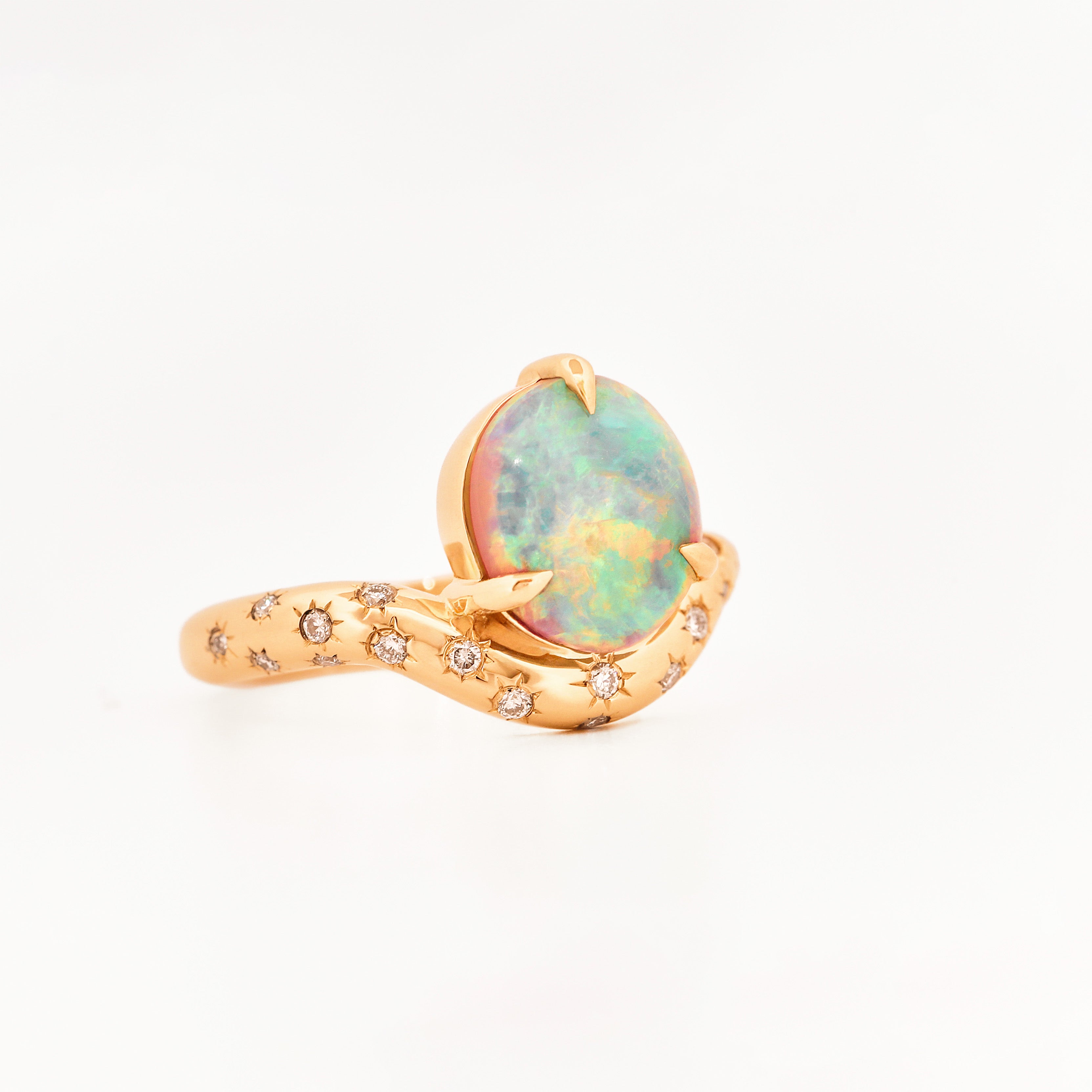 Yellow Gold ring with an australian opal centrestone on a white background.