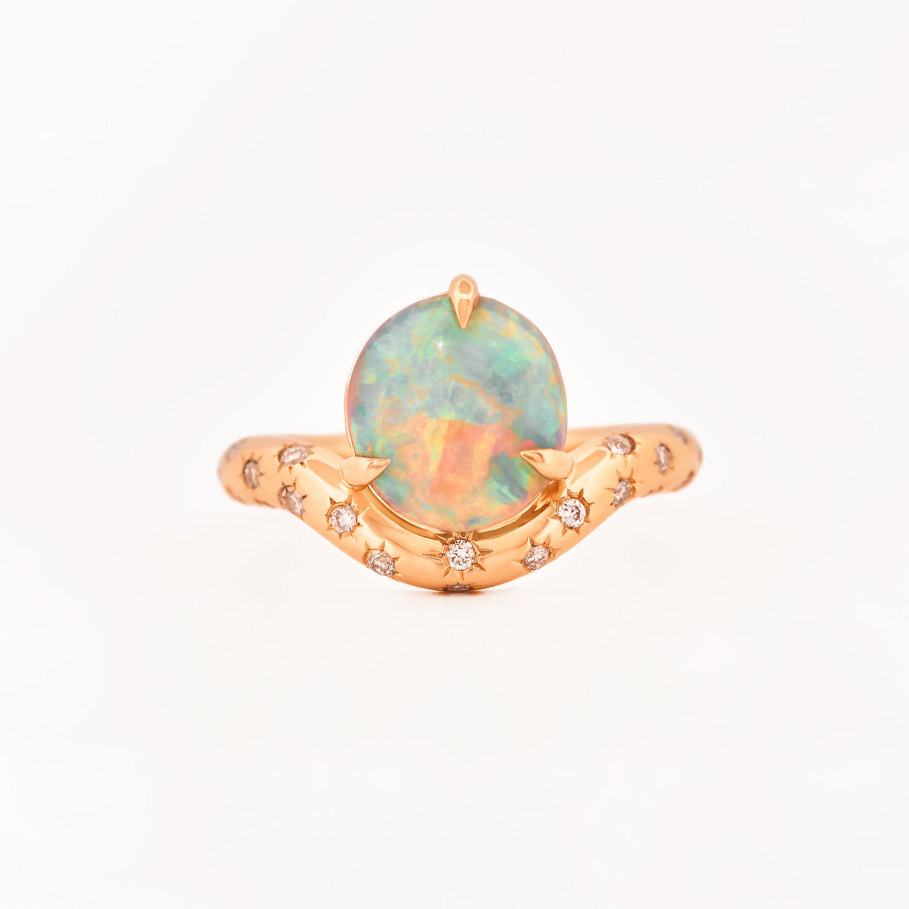 Rose Gold ring with an australian opal centrestone on a white background.