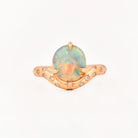 Rose Gold ring with an australian opal centrestone on a white background.