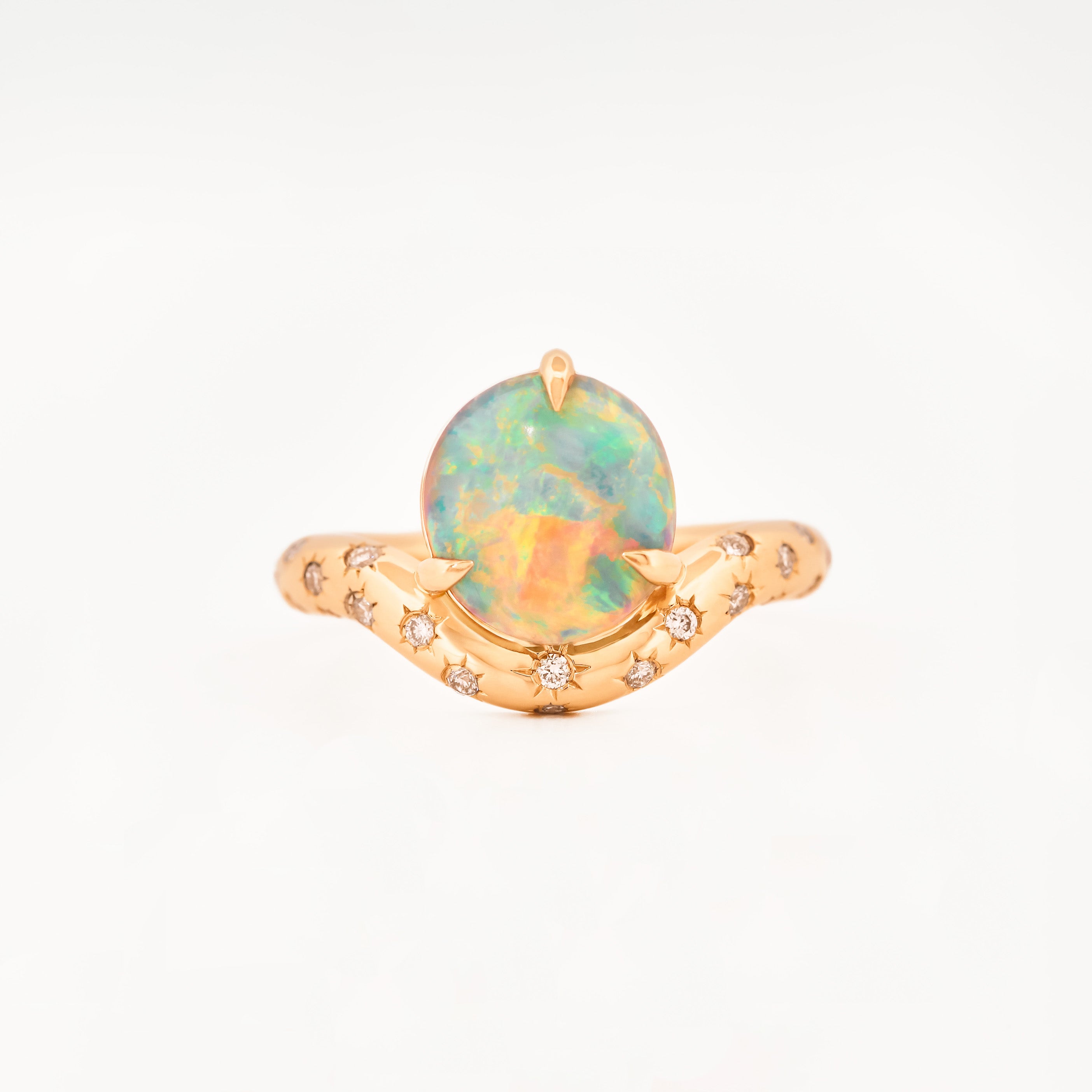 Yellow Gold ring with an australian opal centrestone on a white background.