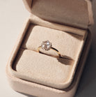 Rose cut Diamond ring in a beige jewelry box on a neutral background