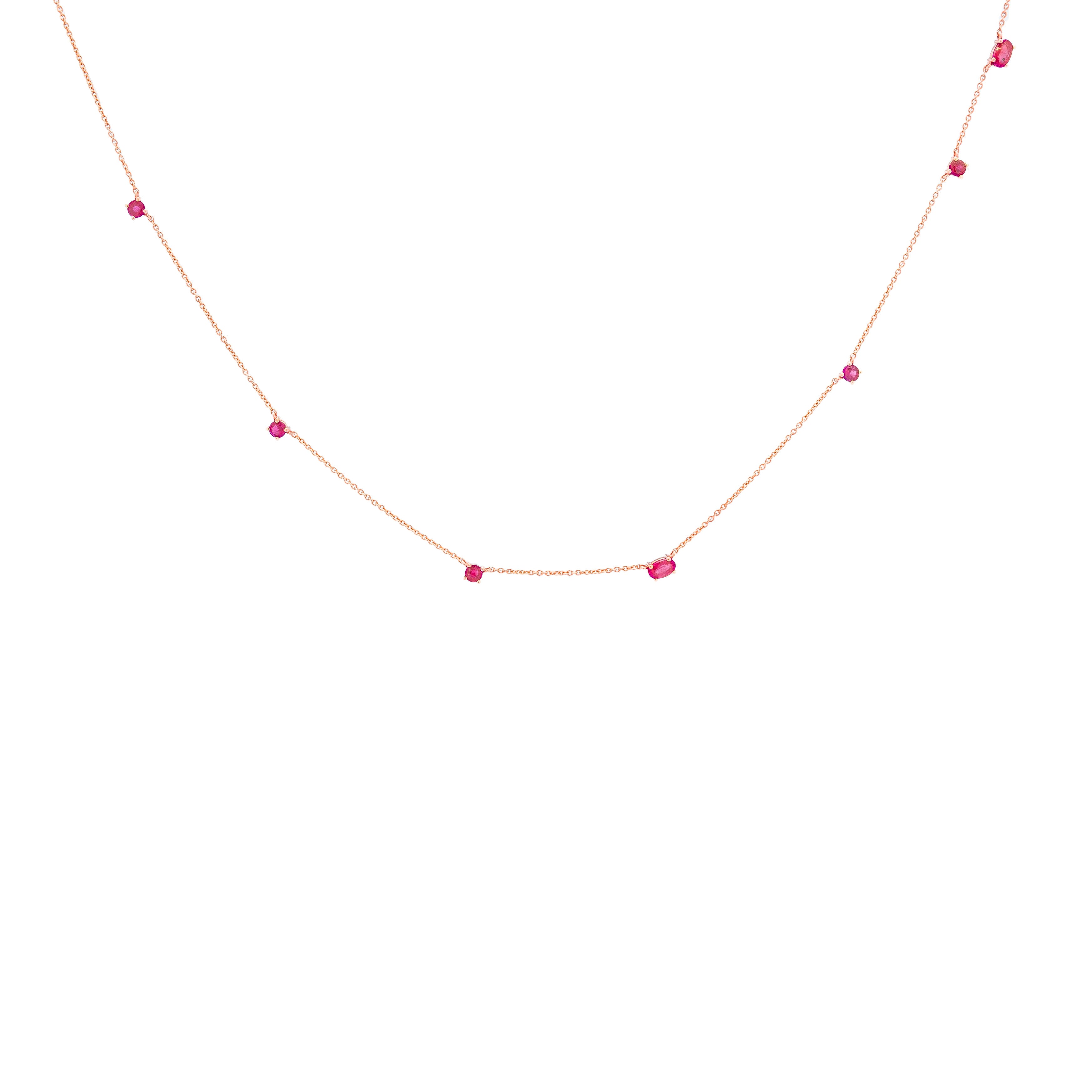 a delicate gold chainlink necklace adorned with natural rubies.