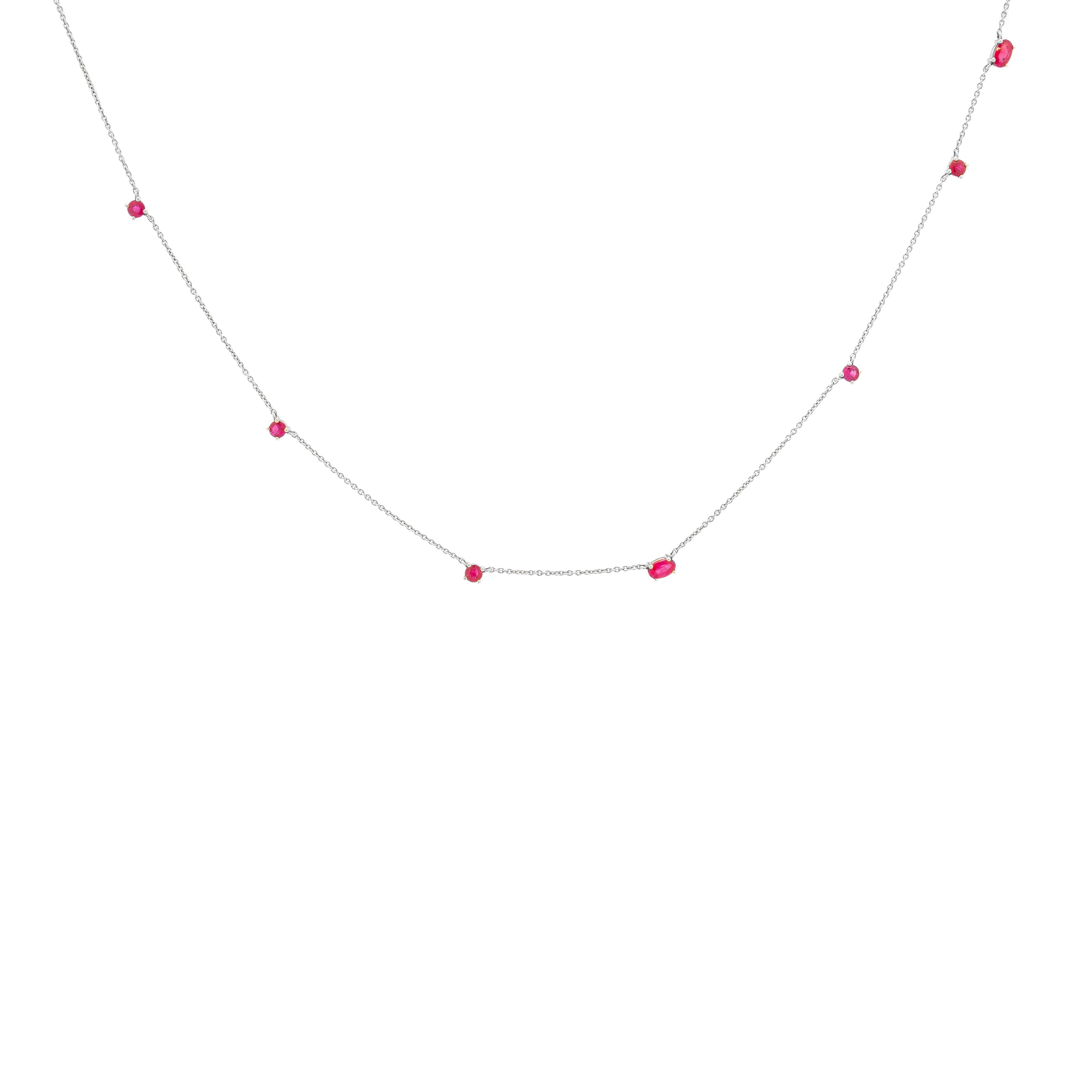 a delicate gold chainlink necklace adorned with natural rubies.