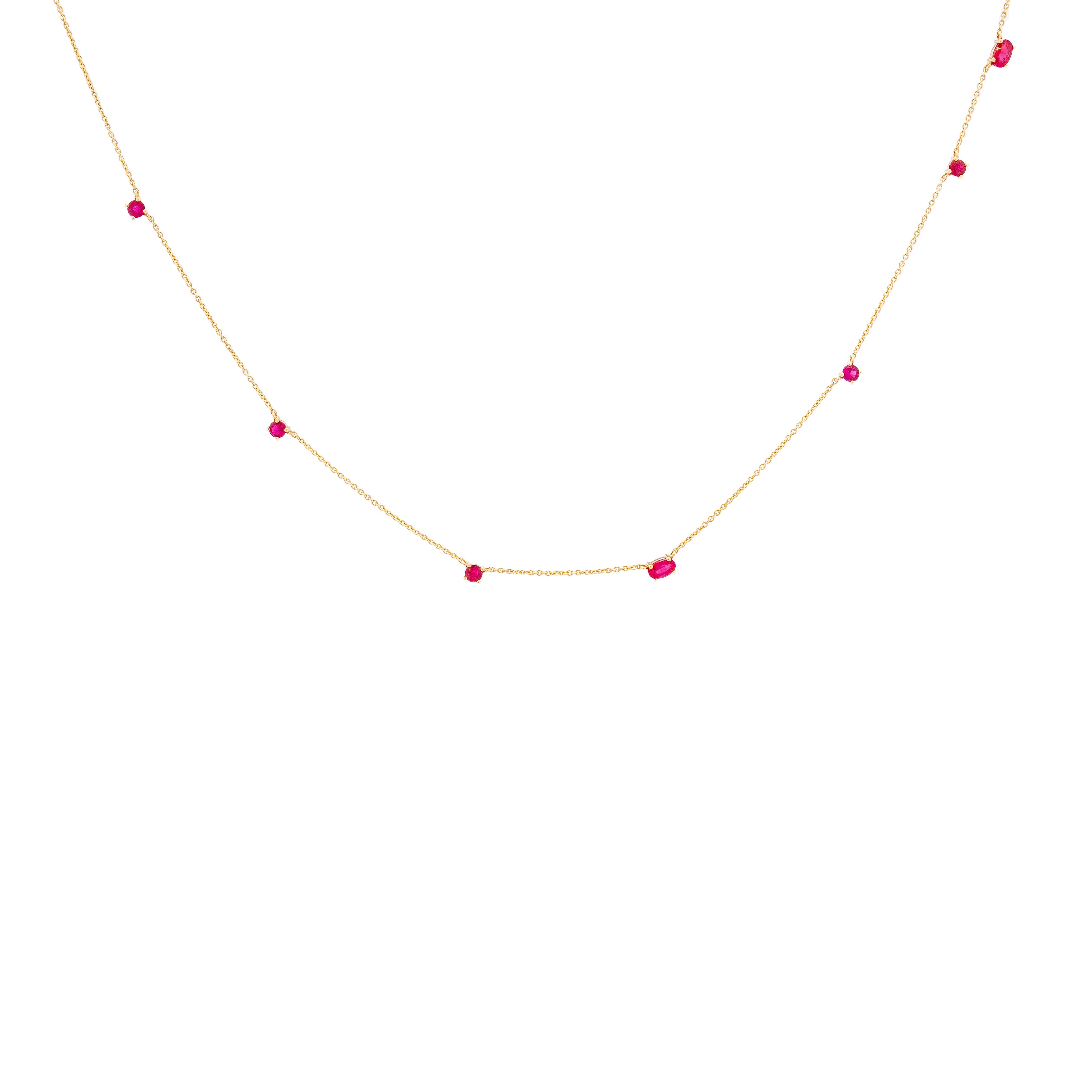 a delicate gold chainlink necklace adorned with natural rubies.