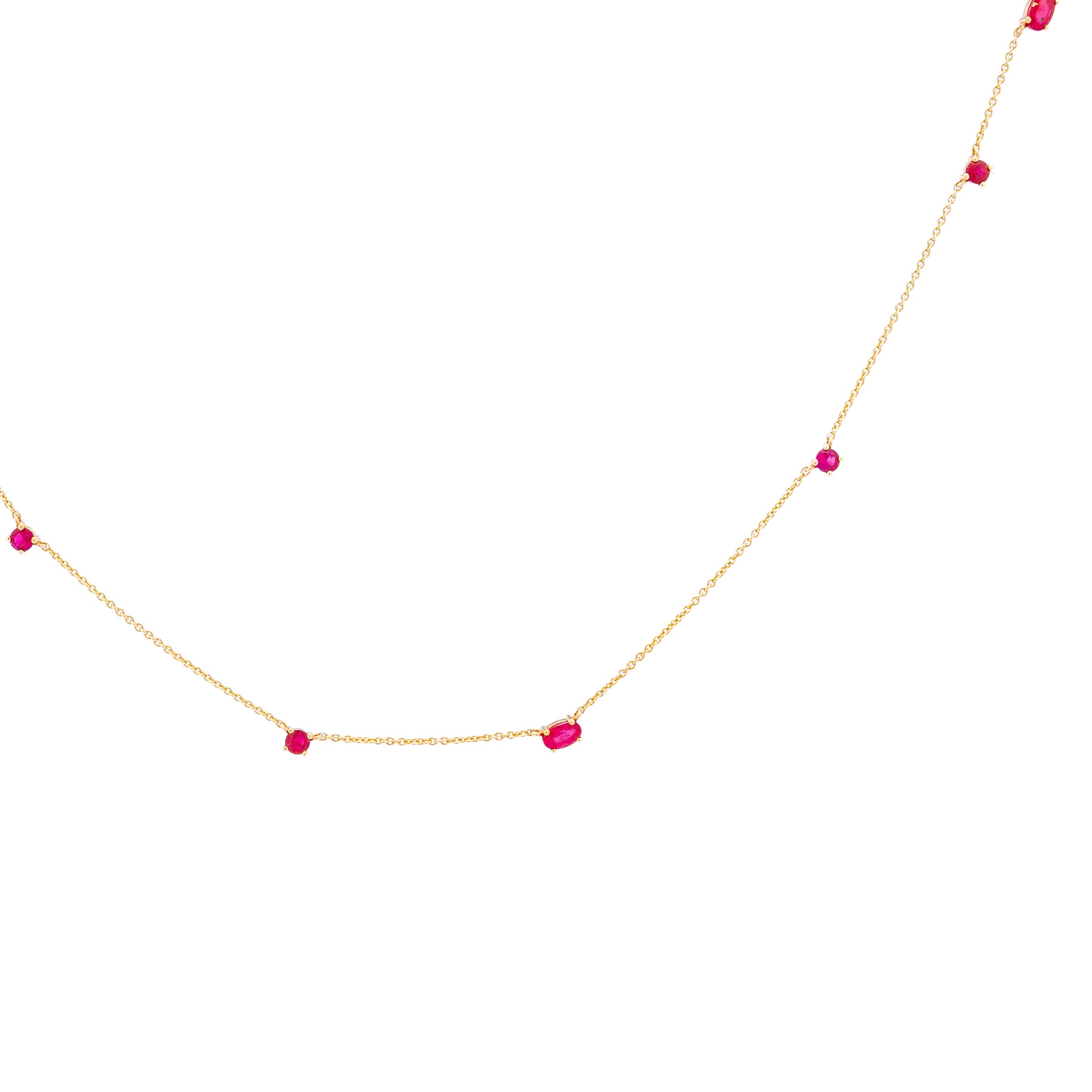 a delicate gold chainlink necklace adorned with natural rubies.