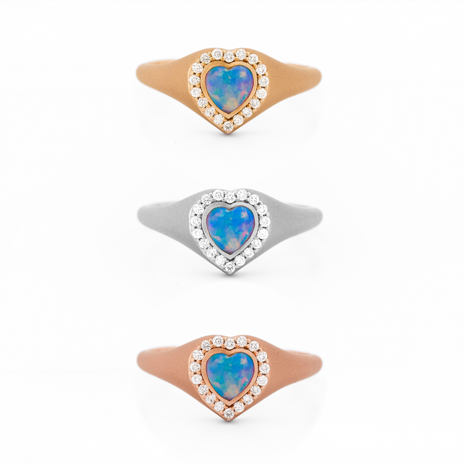Heart-shaped australian opal signet rings with gold and diamonds on a white background