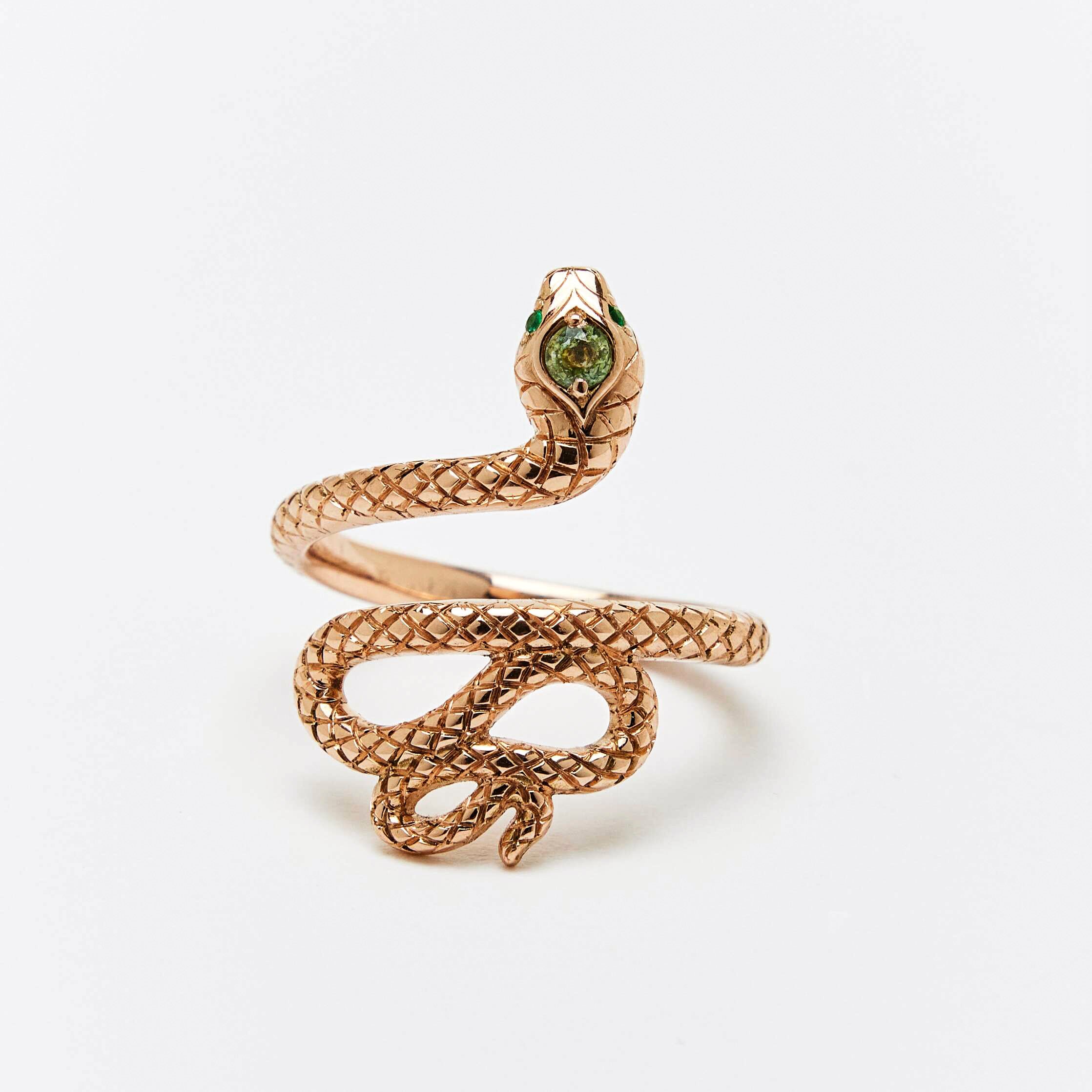 Snake shaped ring with emerald eyes and green sapphire headstone