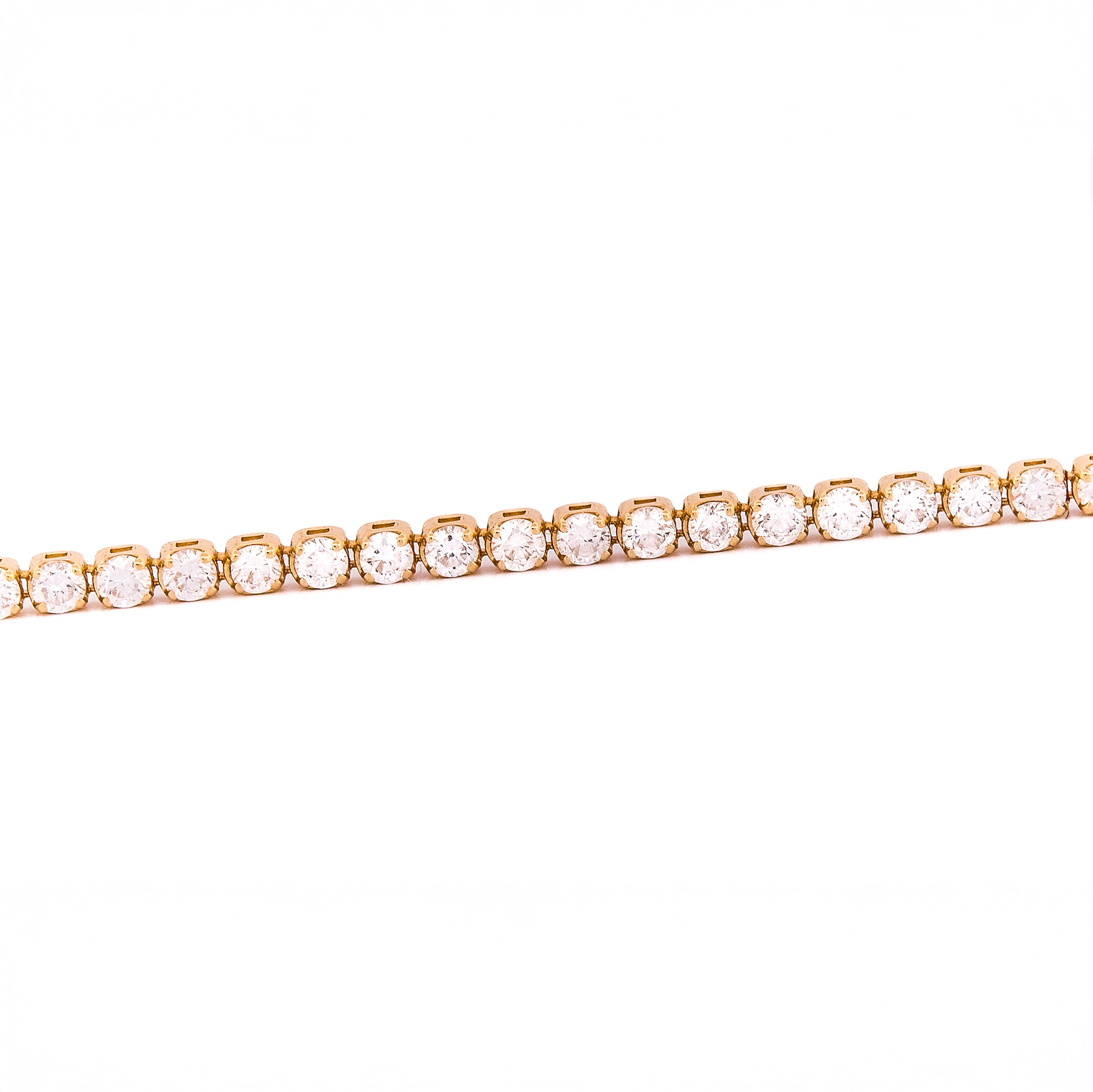 Gold bracelet with diamonds on a white background