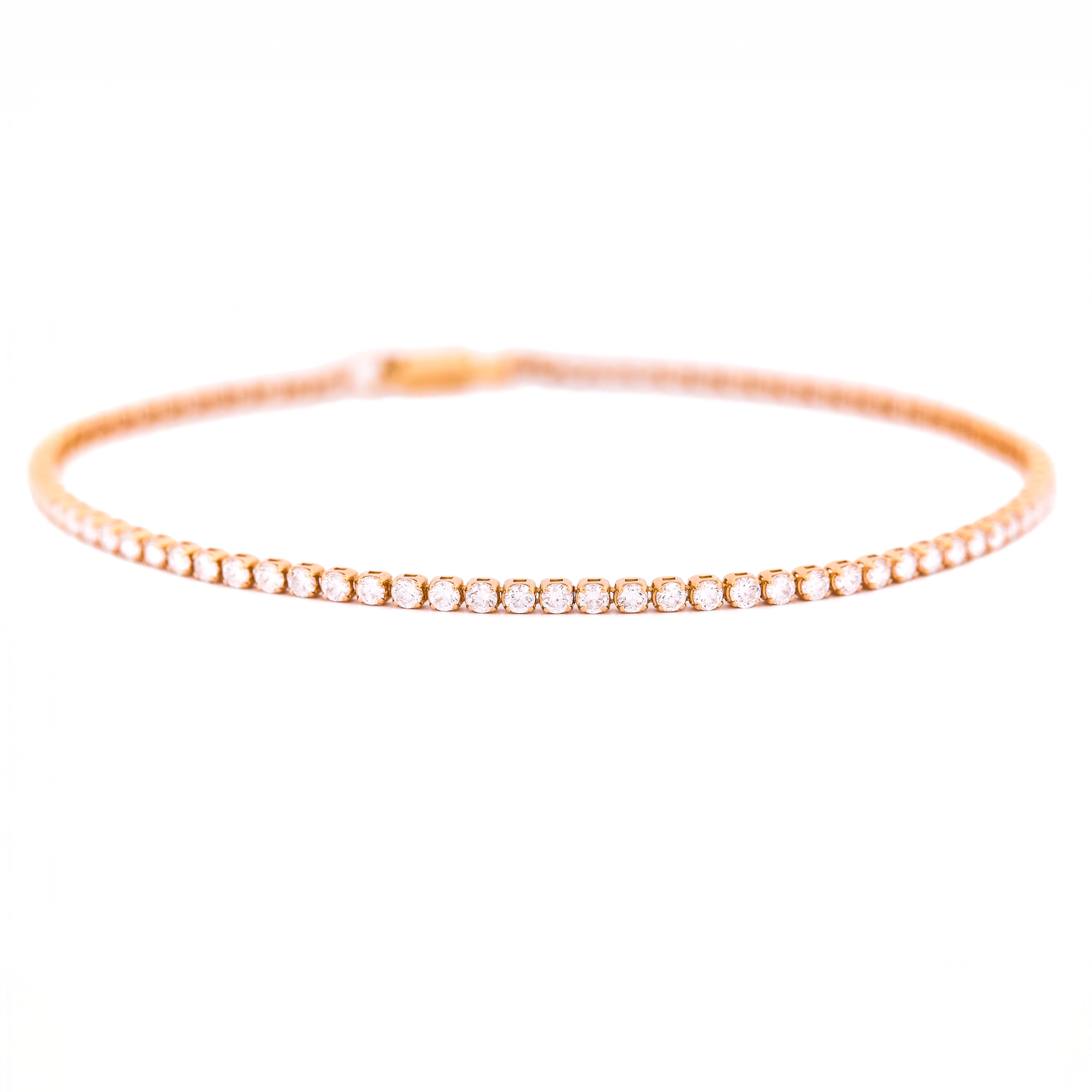 Rose gold bracelet with diamonds on a white background