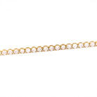Gold bracelet with diamonds on a white background