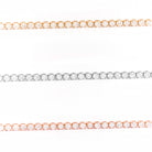 Three diamond tennis bracelets in yellow gold, white gold, and rose gold on a white background