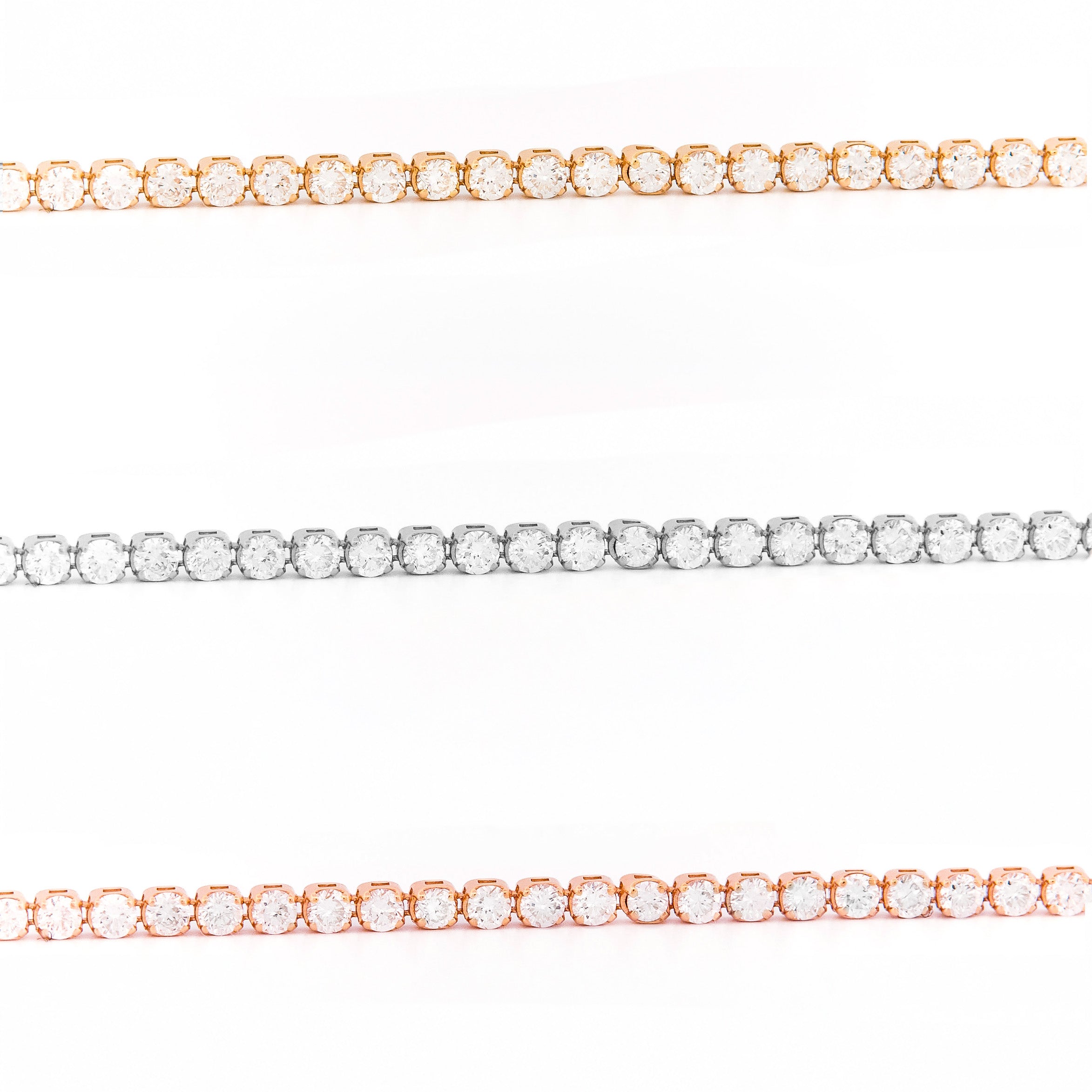 Three diamond tennis bracelets in yellow gold, white gold, and rose gold on a white background