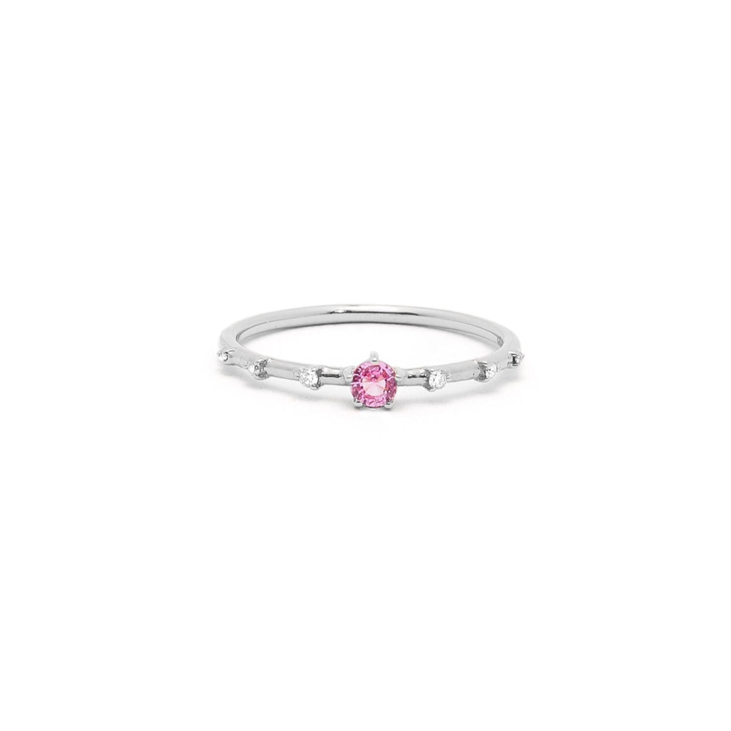 A gold band ring featuring a central sapphire with smaller diamond accents around it, presented against a white background.
