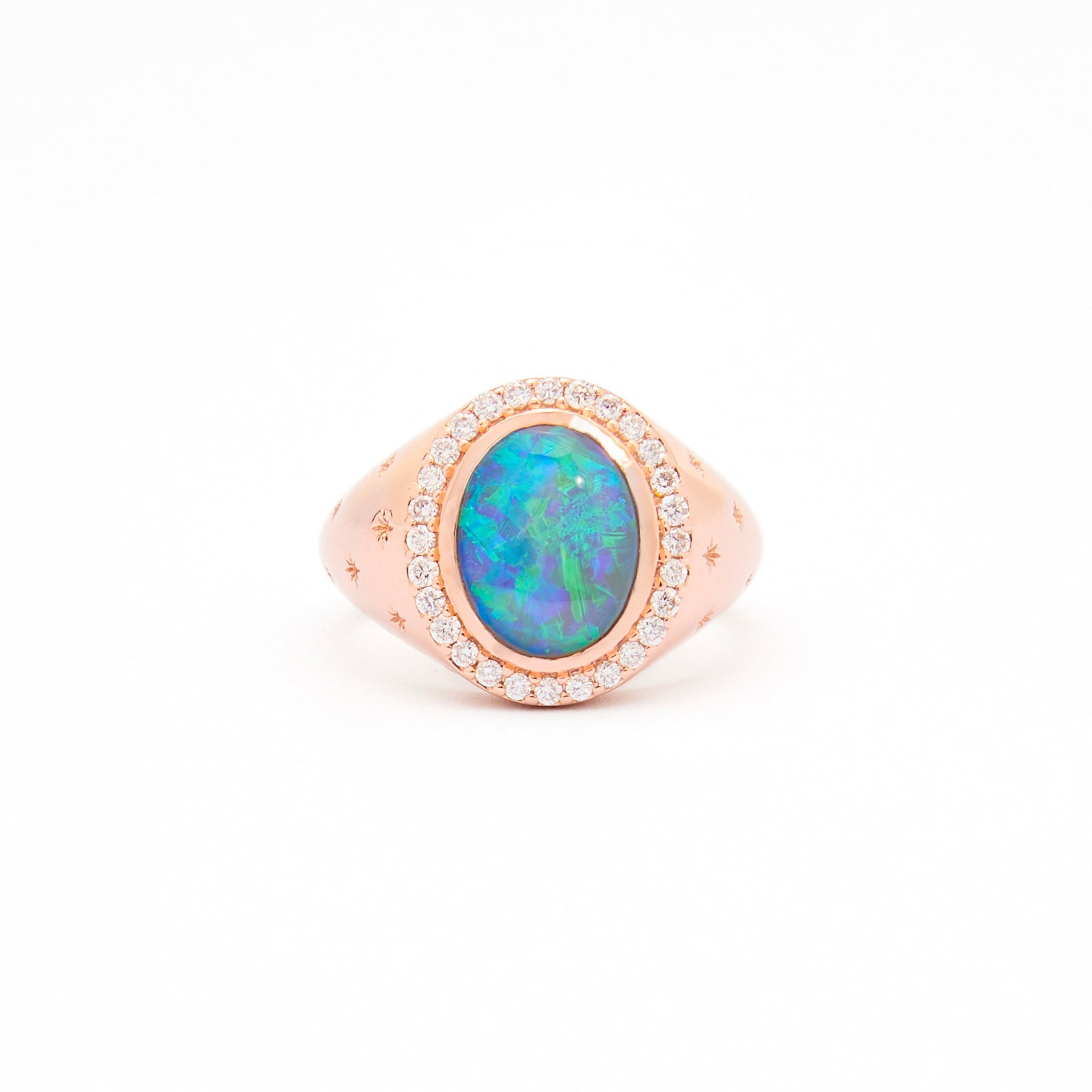 An Australian Opal and Diamonds Signet Ring in rose gold with the opal as the centrepiece, surrounded by white diamonds and set on a white background.