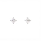 Pair of snowflake-shaped silver earrings on a white background