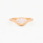 Yellow gold solitaire ring with a marquise diamond on a white background.