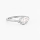 white gold solitaire ring with a marquise diamond on a white background